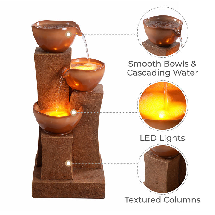 A 28.54" 3-Tier Outdoor Water Fountain with LED Lights, Brown, featuring smooth bowls, cascading water, and textured columns.