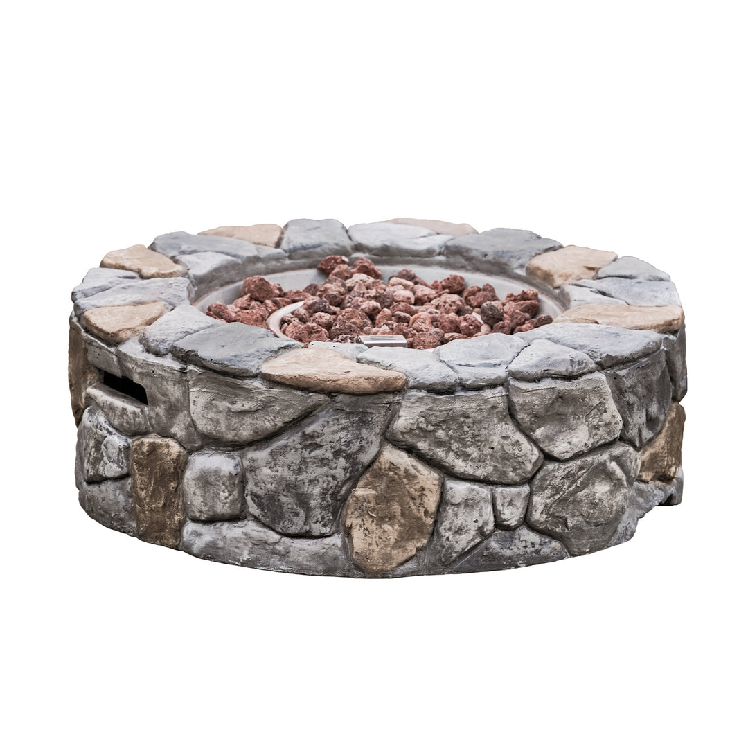 A Teamson Home 28" Outdoor Round Stone Propane Gas Fire Pit, Stone Gray, with the rustic lava rocks around the fire ring