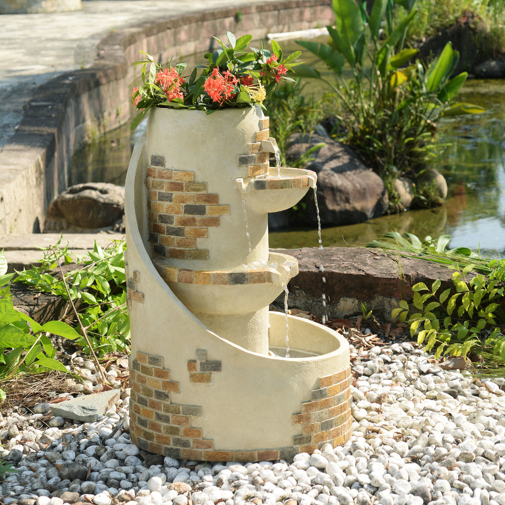 29.92" Outdoor Water Fountain with Planter & LED Lights, Ivory with running water and potted plants in a garden setting next to a pond