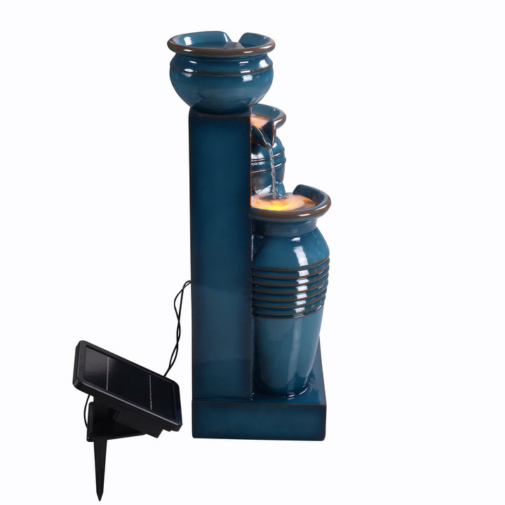 Side view of the Teamson Home 28.74" Blue 4-Tier Outdoor Solar Water Fountain with a clear view of the top of cascading pots and the solar panel on a spike