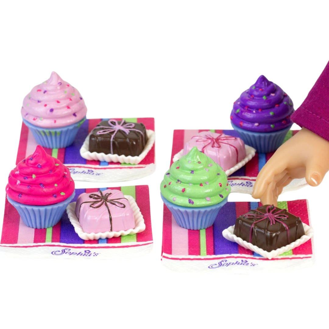 A close-up of pretend, colorful, baked goods on striped napkins for 18" dolls.