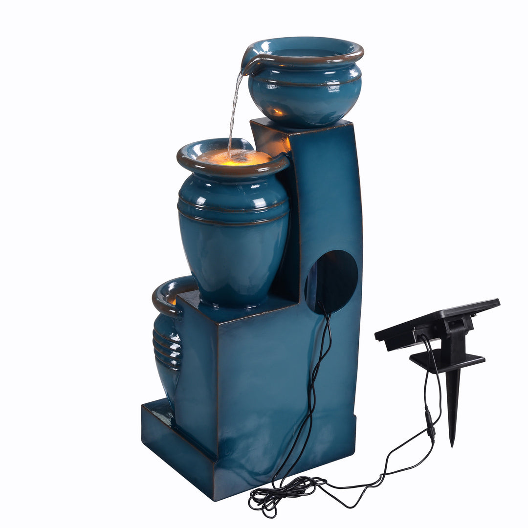 Teamson Home 28.74" Blue 4-Tier Outdoor Solar Water Fountain with a hole in the back where the pump is inserted and the cord that leads from the solar panel to the pump is located. 