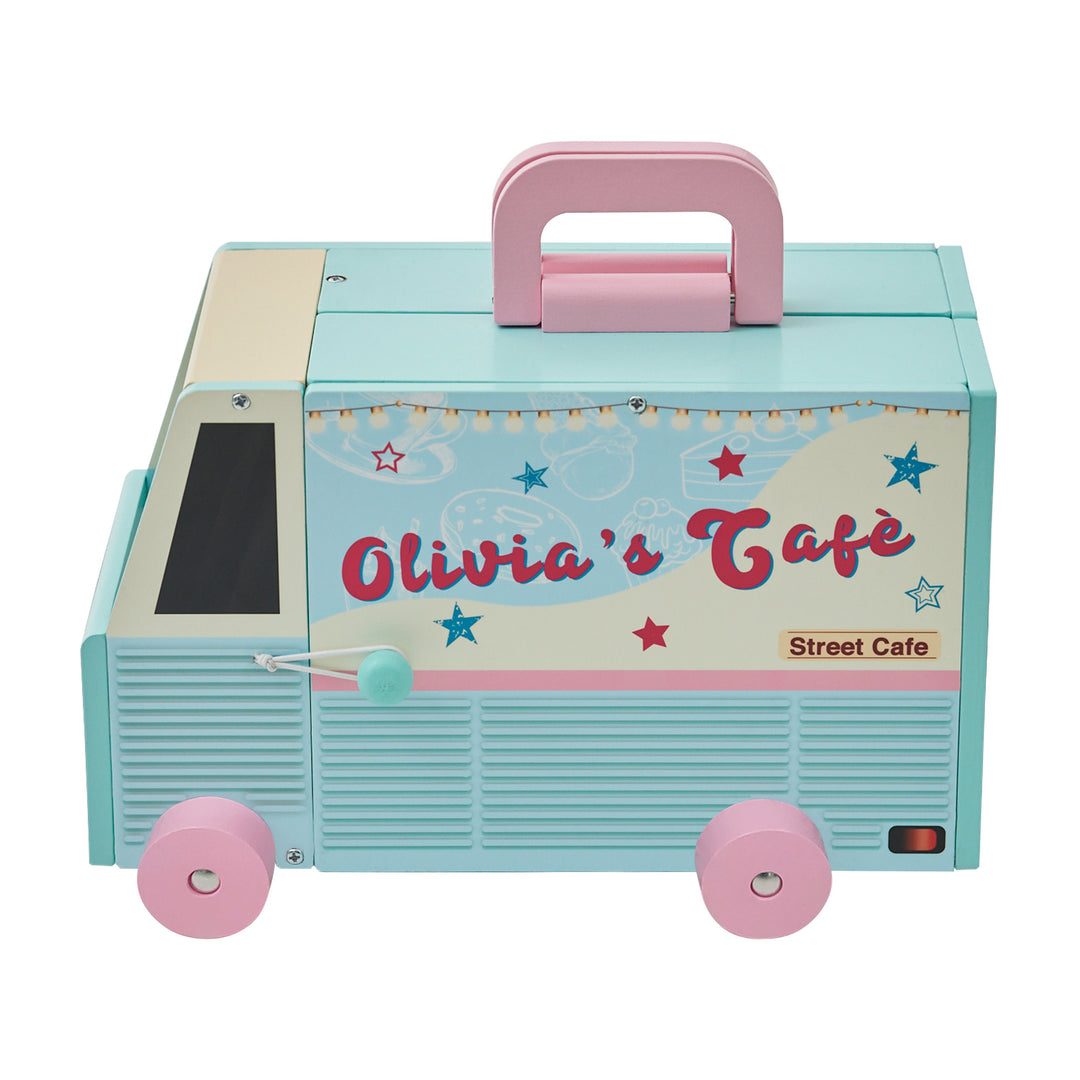 A blue and pink toy food truck, closed with a decorative "Olivia's Cafe Street Cafe" sign on the side.