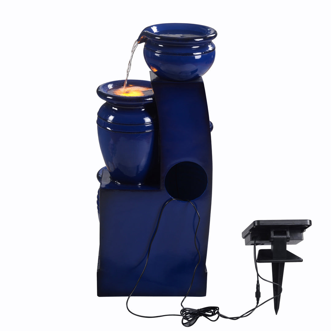 A view from behind of the Teamson Home 28.74" Navy Blue 4-Tier Outdoor Solar Water Fountain with LED Lights with a hole in the back where the pump is located
