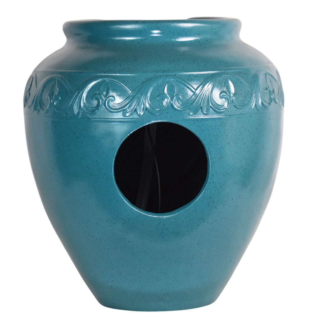 View of the opening on the back of a teal vase-shaped water fountain