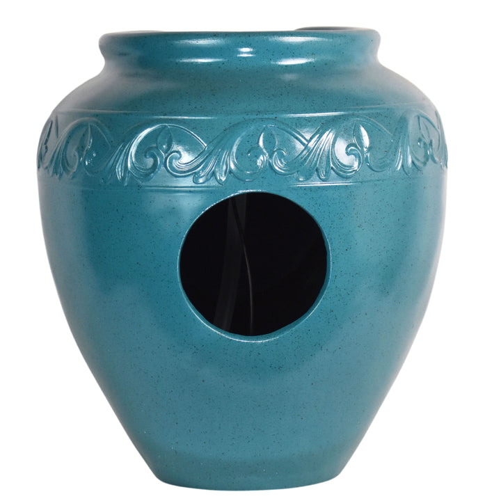 View of the opening on the back of a teal vase-shaped water fountain