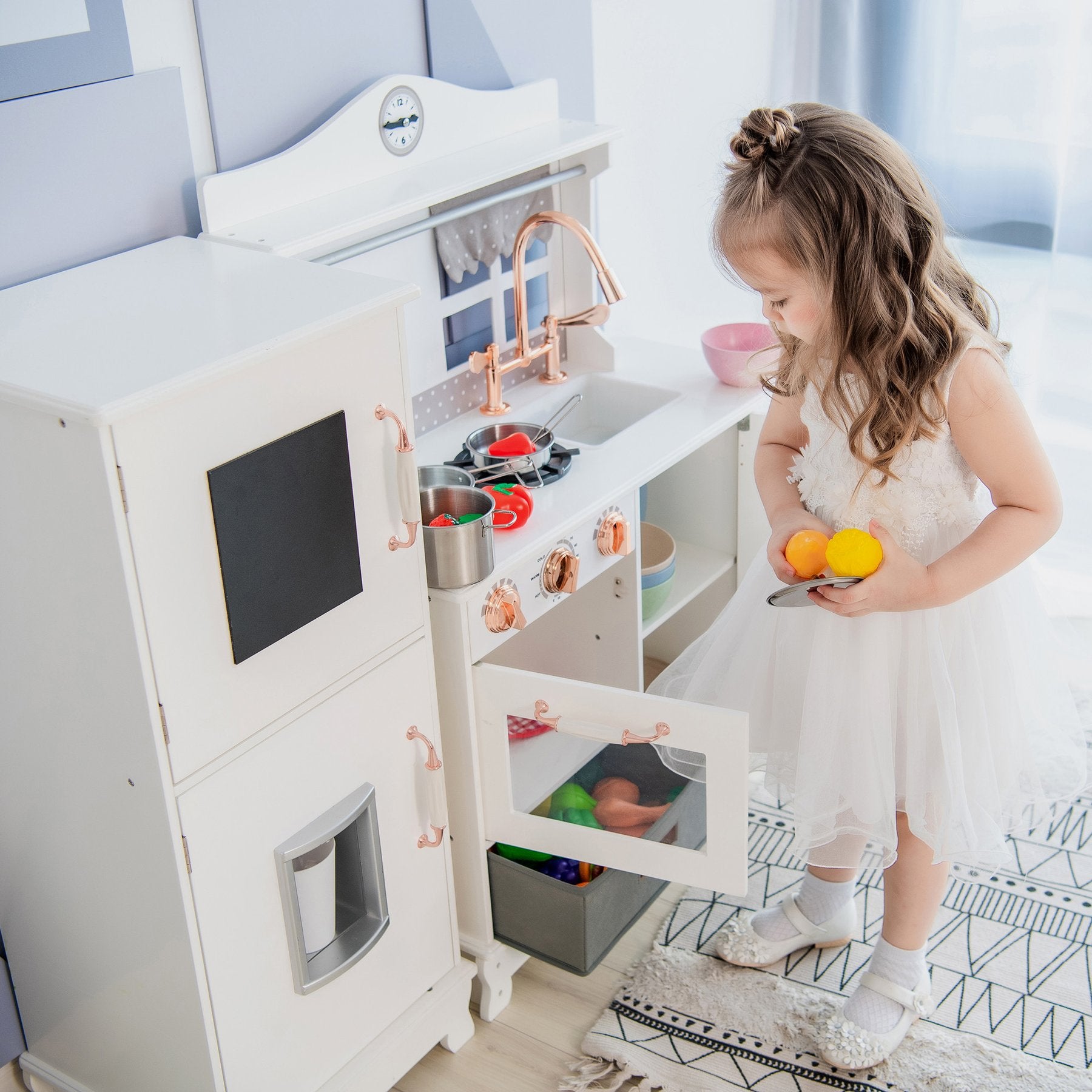 Kid playing with a white retro play kitchen.