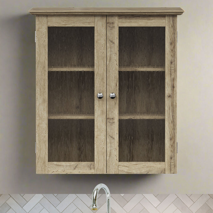 Light oak finished two-door wall cabinet hanging over a sink on a tan wall.