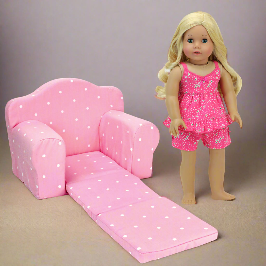 an 18 inch doll stands next to a pull out chair in a living room