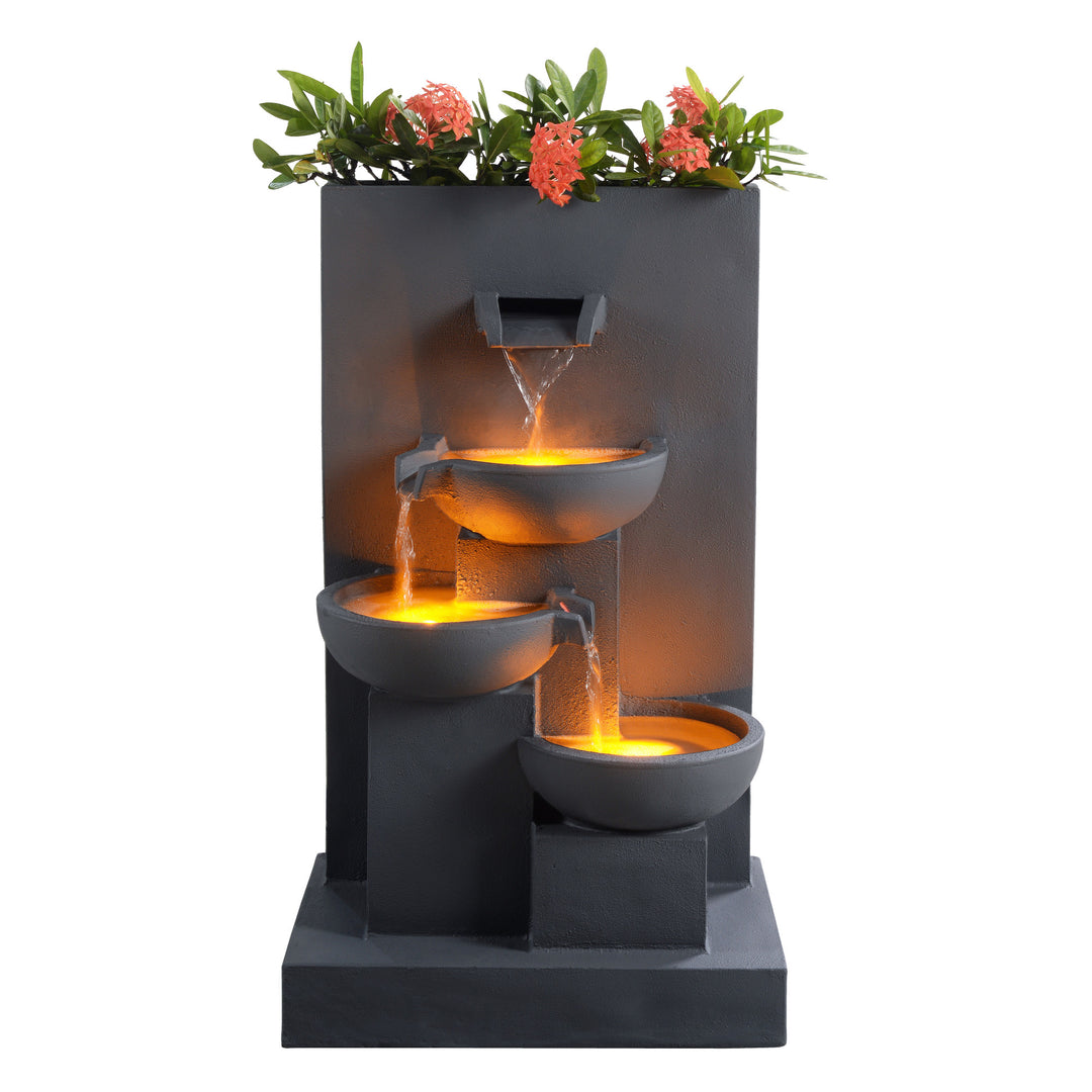 A view of the front of Teamson Home's 29.13" Outdoor Water Fountain with Planter & LED Lights, Matte Gray, with the LED lights on and the water flowing