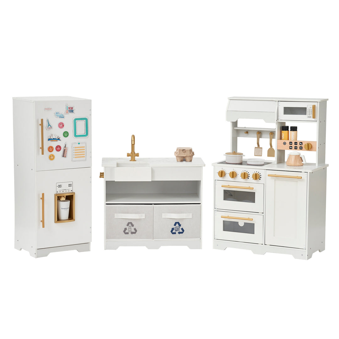 A set of Teamson Kids - Little Chef Atlanta Large Modular Play Kitchen, White/Gold furniture, including a fridge, sink with cabinets, and a stove.