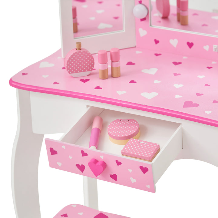 Close-up of the storage drawer with some play make-up pieces inside.