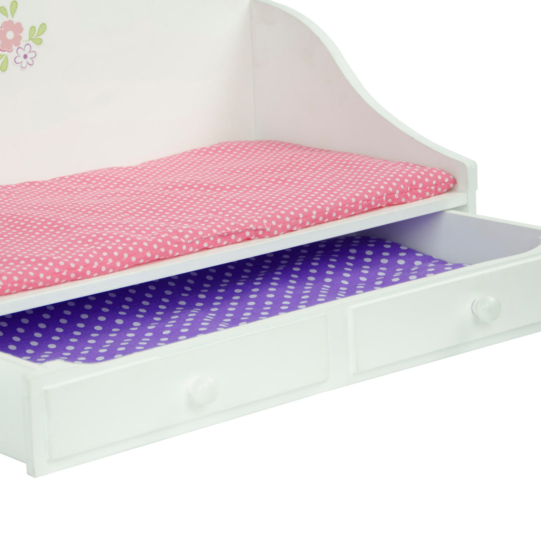 Close-up of the bed and the trundle drawer with a pink mattress and purple mattress.
