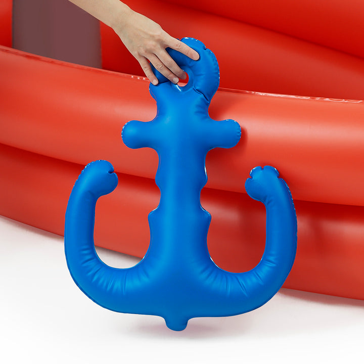 A person holding a Teamson Kids - Water Fun Pirate boat Inflatable Sprinkler Play in front of a red background.