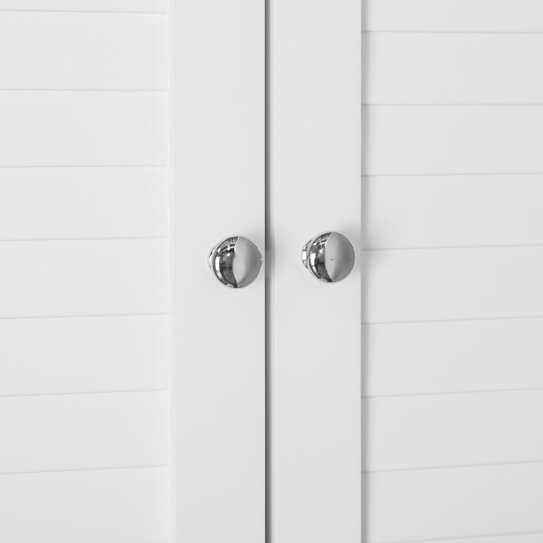A close-up of the chrome knobs on the cabinet doors on the White Teamson Home Louis Over-the-Toilet Cabinet with Louvered Doors and an Open Shelf
