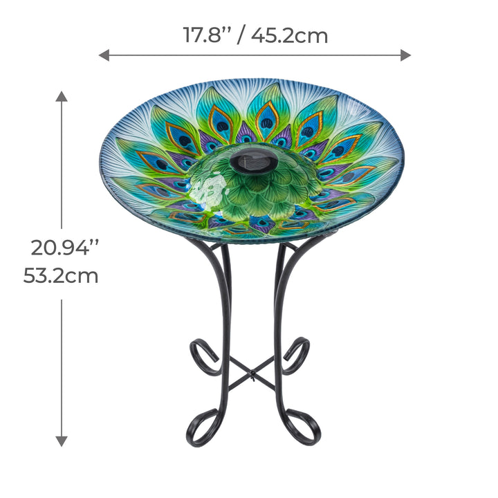 Decorative 17.8" Peacock Fusion Glass Birdbath on a wrought iron stand with peacock feather design, including dimensions in inches and centimeters