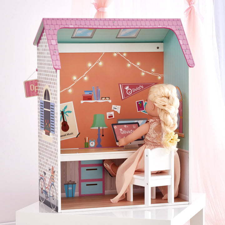 A 4-in-1 18" doll playset with the homework nook facade with a blonde doll dressed in a blush dress working at her desk.