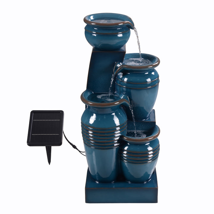 The Teamson Home 28.74" Blue 4-Tier Outdoor Solar Water Fountain without the lights turned on but the fountain still running