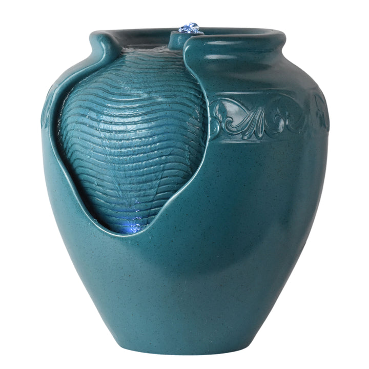 Close-up of the textured surface with water flowing over it on a teal vase-shaped water fountain