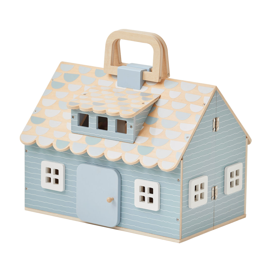 A view of the cottage dollhouse, blue with detailed shingles and windows, and the handle pointing up.