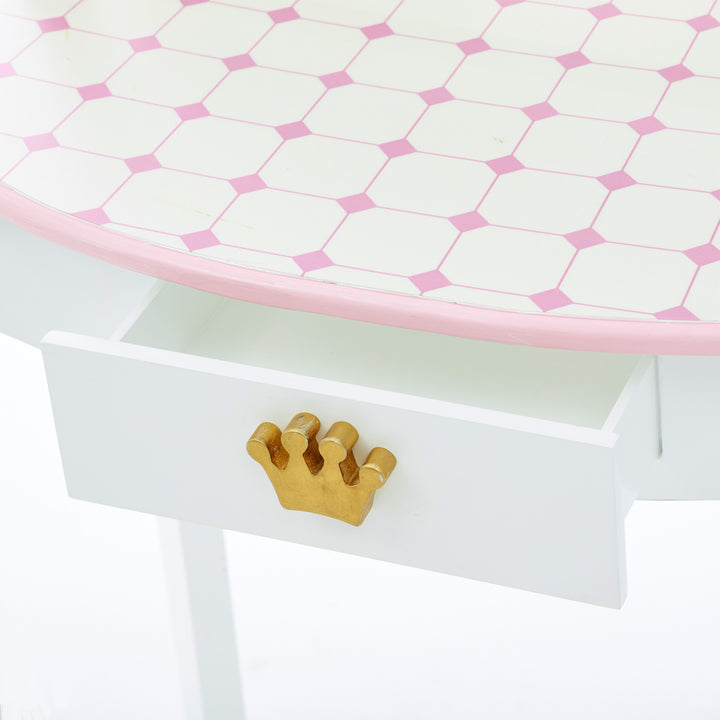 The open storage drawer of the Dreamland Castle Vanity Set with Chair and Accessories, White/Pink with a crown on it.