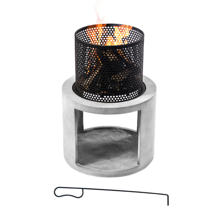 A Teamson Home Outdoor 16" Wood Burning Fire Pit with Decorative Log Storage Base, Gray/Black with a fire burning inside and a poker next to it