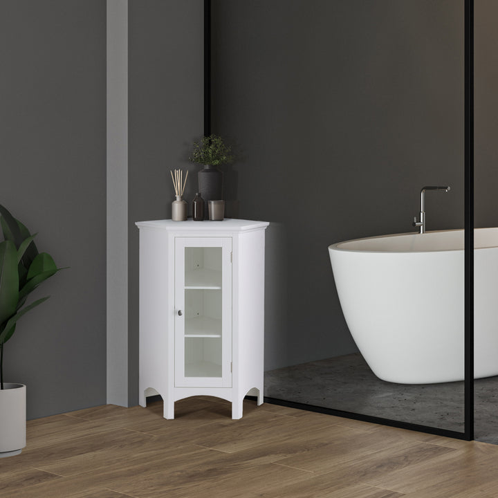 A Teamson Home Madison Corner Floor Storage Cabinet, White in a gray bathroom next to a tub and potted plant