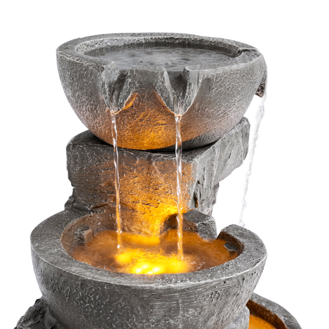 A close-up of the top two tiers of the Teamson Home Outdoor Cascading Bowls & Stacked Stone water fountain, gray