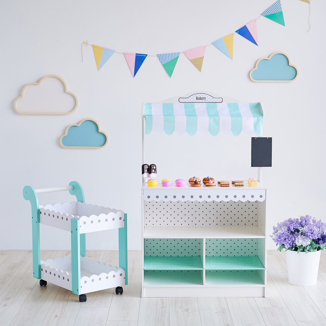 Teamson Kids My Dream Bakery Shop, Treat Stand and Dessert Cart in White and Blue is shown in a whimsical playroom for kids