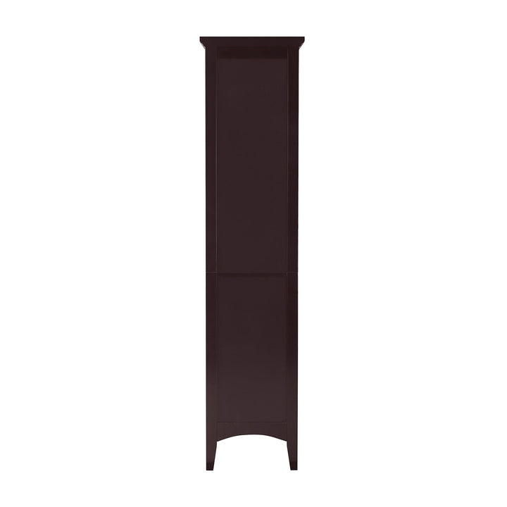 A back view of the A Dark Brown Teamson Home Glancy Linen Cabinet with louvred doors