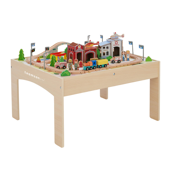 Teamson Kids Preschool Play Lab Toys Wooden Table with 85-pc Train and Town Set, Natural on a table with track arrangement, buildings, and trees.