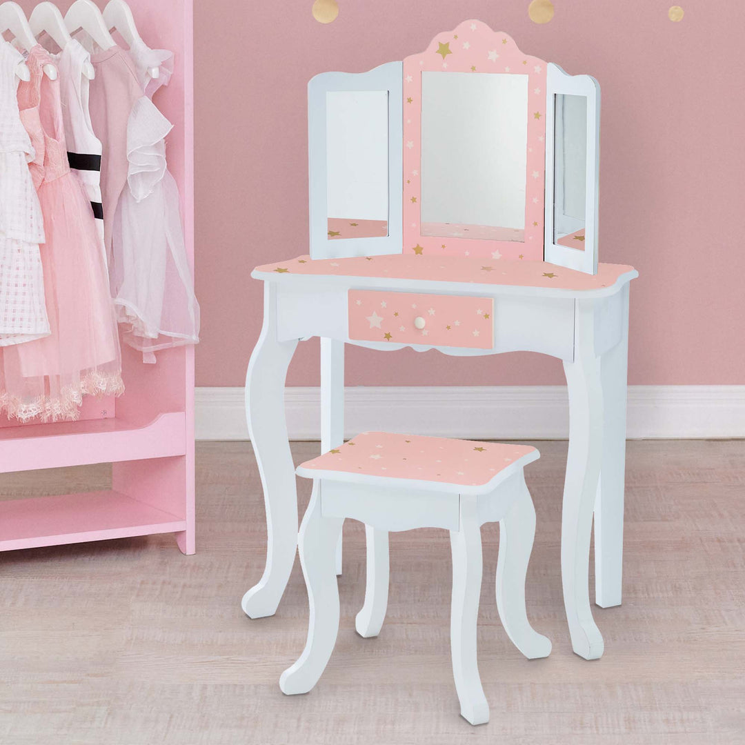 A pink and white Fantasy Fields Gisele Play Vanity Set with Mirrors, Pink/White with a mirror and stool.