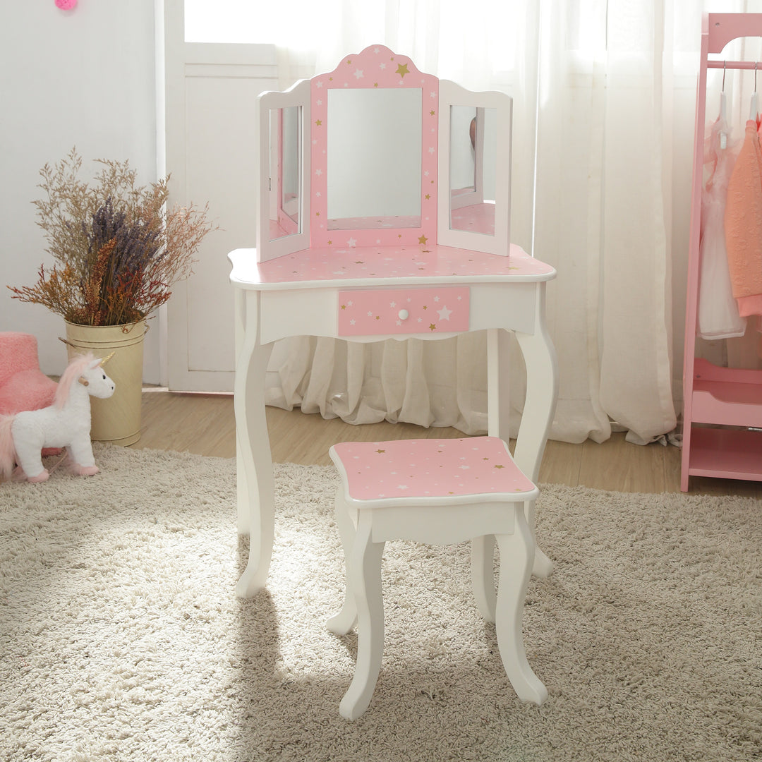 A girl's bedroom with a pink Fantasy Fields Gisele Play Vanity Set with Mirrors and stool.