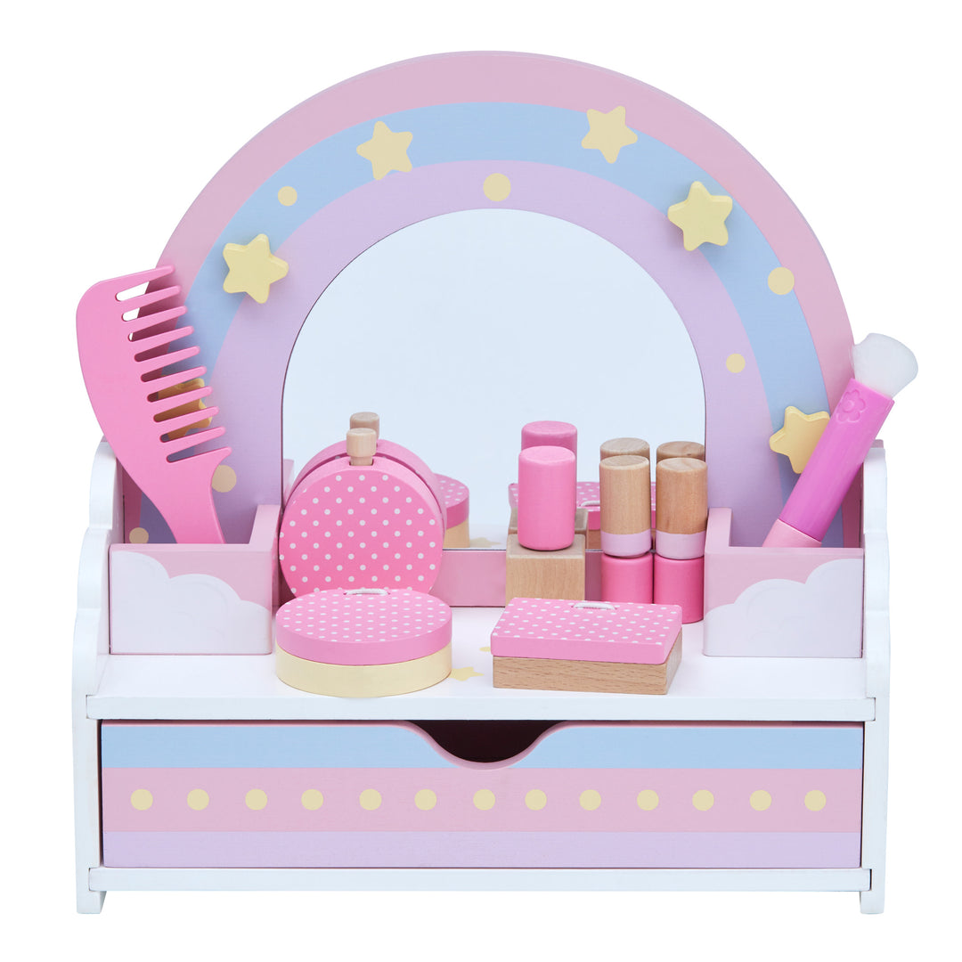 A kid's tabletop vanity with a storage drawer, rainbow accents and a mirror with pretend eyeshadow pallette, compact, comb, makeup brush, booklet, nailpolish, perfume, and two lipsticks.