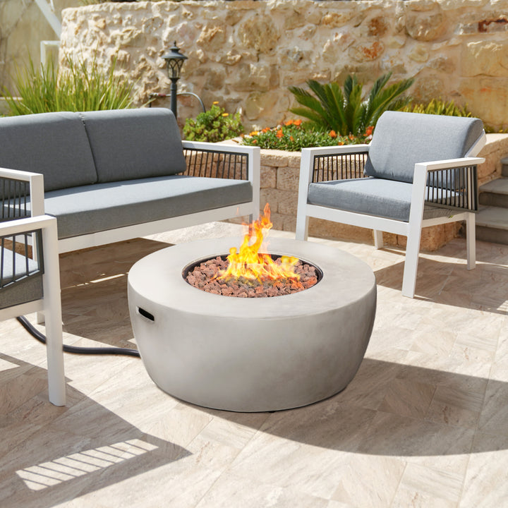 Modern outdoor seating area with a sturdy construction Teamson Home 36" Outdoor Round Propane Gas Fire Pit with Faux Concrete Base, Gray centerpiece.