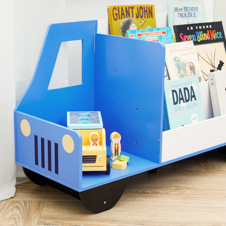 A Fantasy Fields Truck Wooden Display Bookcase, White/Blue with a toy truck on it in a children's bedroom.