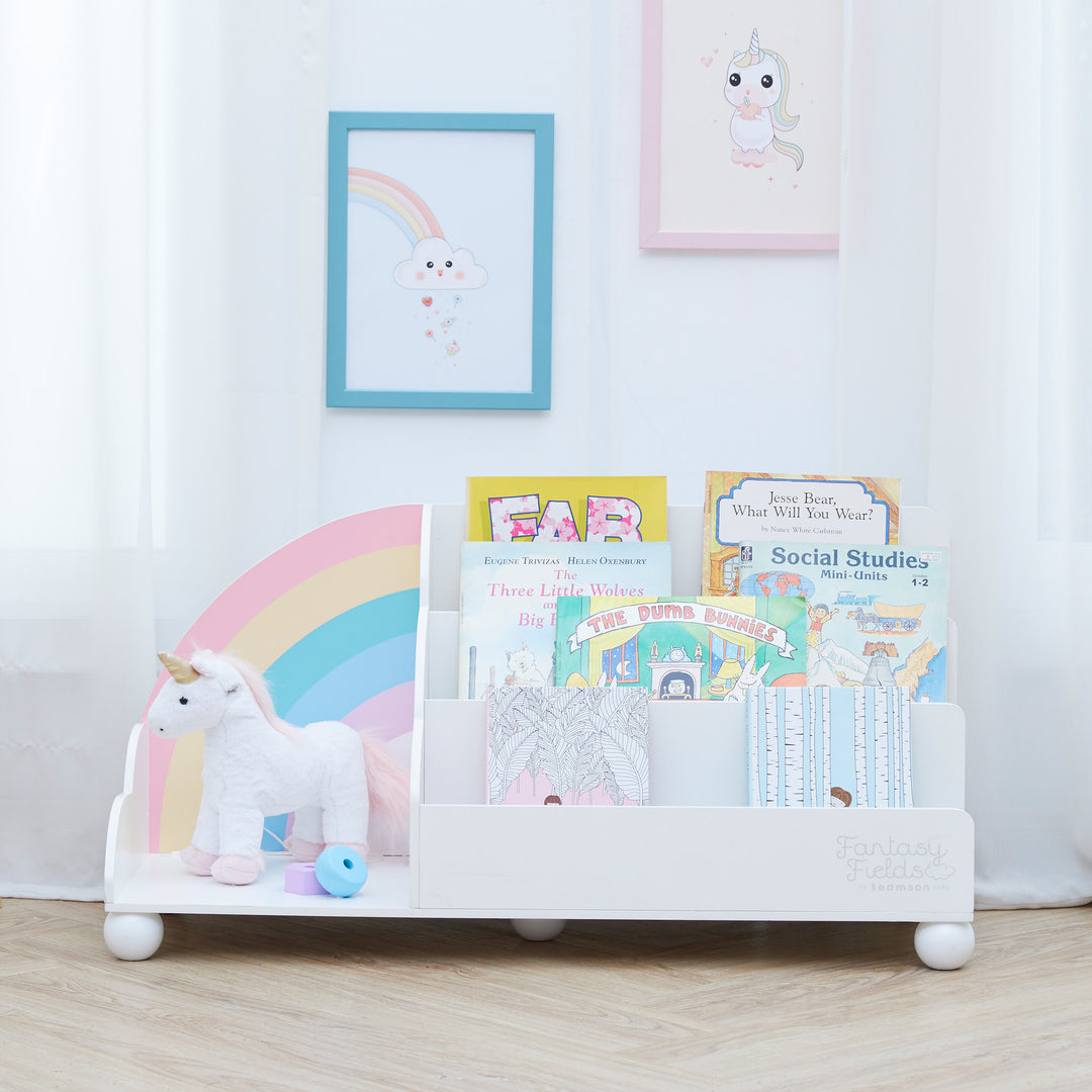 Fantasy Fields  Rainbow Wooden Display Bookcase, White sitting on the floor in front of a white curtain.