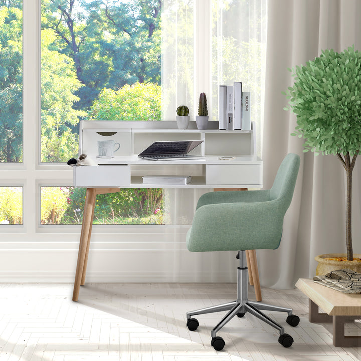 Teamson Home Modern Office Chair, Mint, next to a white writing desk in front of a window