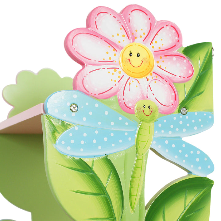 Close-up of the pink and yellow flower and blue and green dragonfly on the bookshelf.