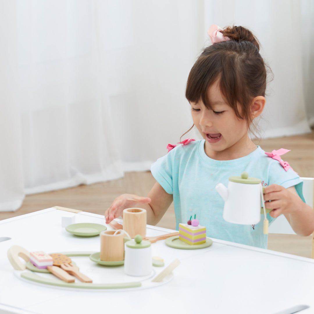 A girl plays with the Little Chef Frankfurt Wooden Tea sets play kitchen accessories 