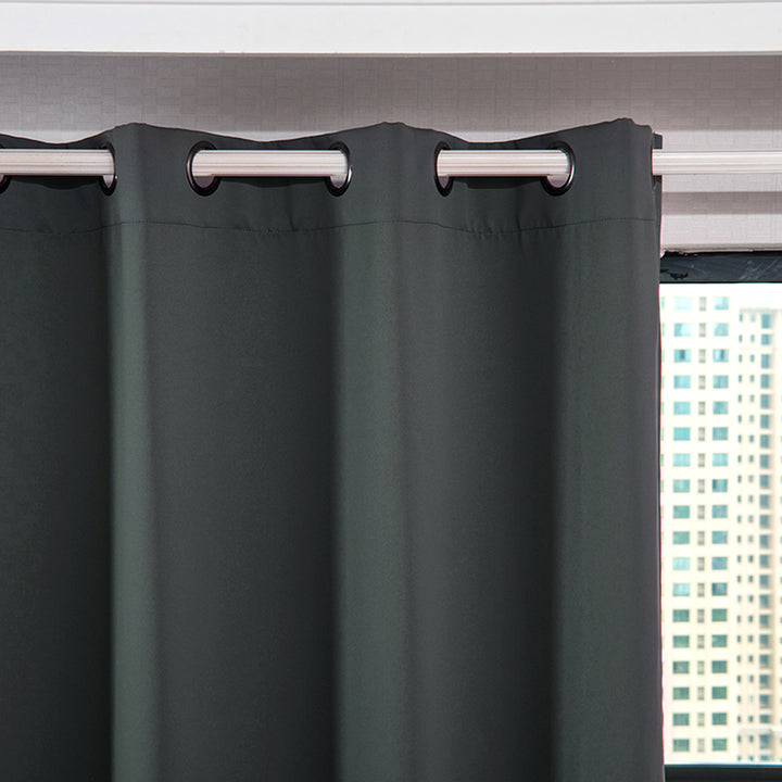 Teamson Home 84" Delphi Premium Thermal Blackout Grommet Window Panels with Grommets, Gray hanging in front of a window with a city view in the background.