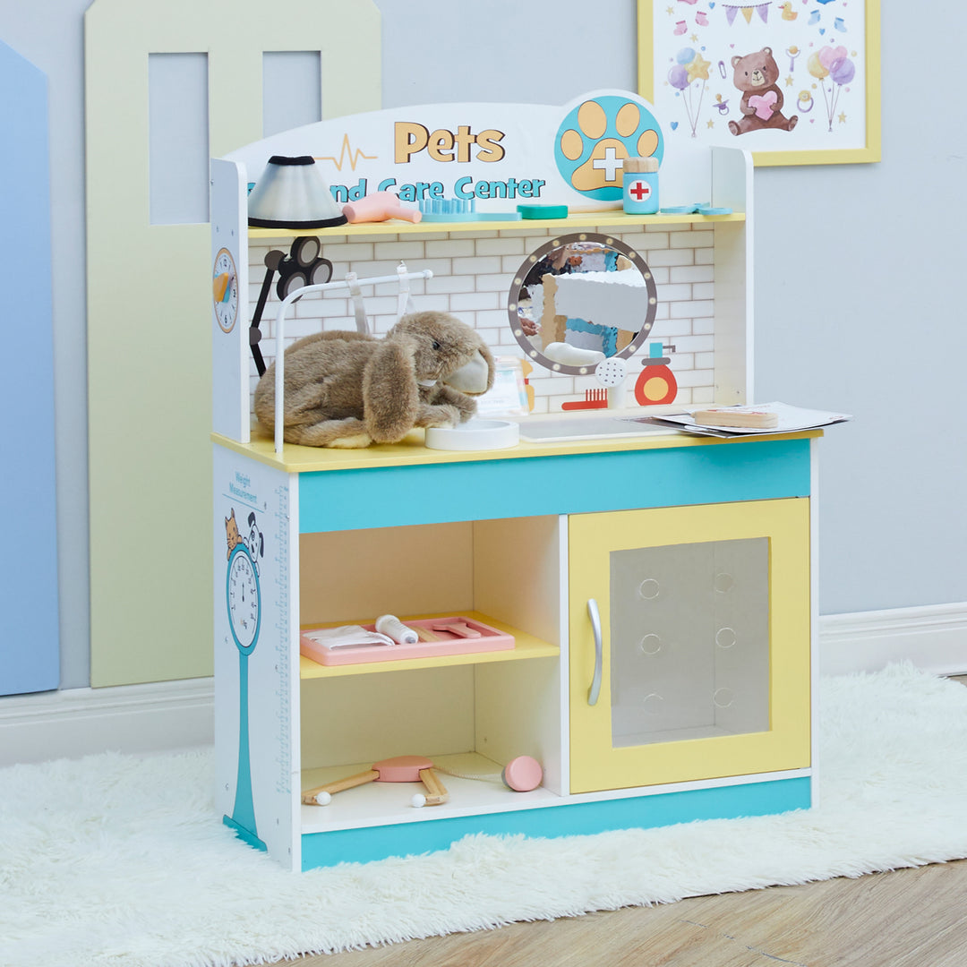Teamson Kids Little Helper Wooden Pet Care and Veterinary Clinic Playset simulating a veterinary activity center with plush rabbit and various pretend vet exam accessories.