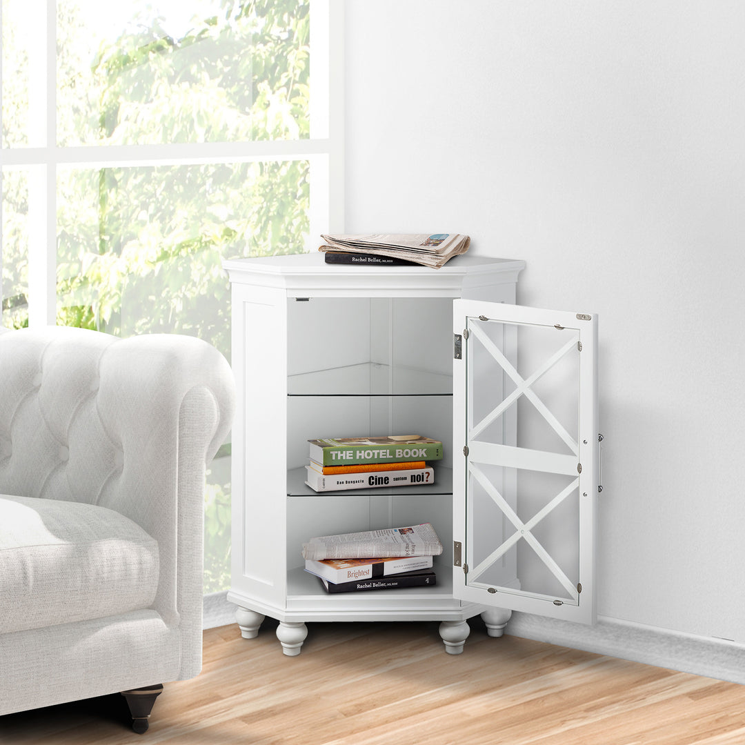 A White Teamson Home Blue Ridge Corner Floor Cabinet in the corner of a living room next to a white sofa with books inside and on top