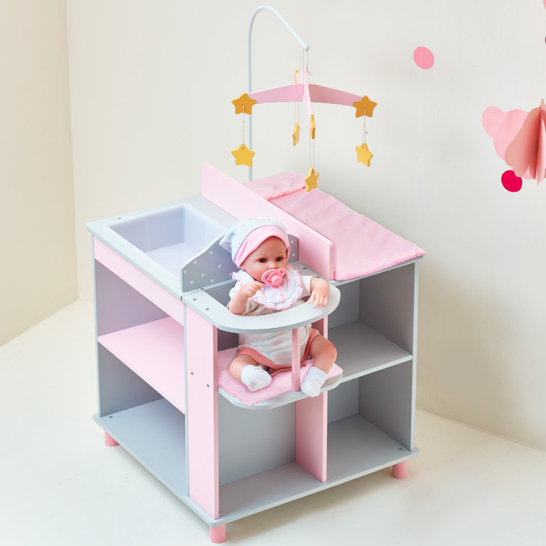A baby is sitting in high chair in the baby doll changing station in gray and pink.