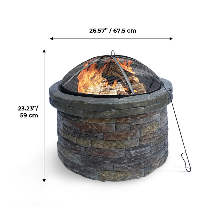 A Teamson Home 27" Outdoor Round Stone Wood Burning Fire Pit with Steel Base, Natural Stone with dimensions labeled, displaying a height of 23.23 inches and a diameter of 26.57 inches, with a fire burning inside and a metal mesh