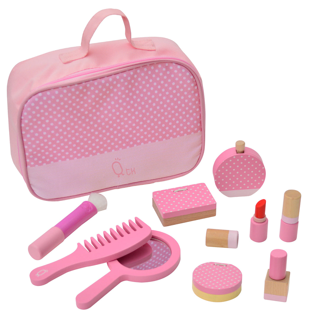 Yhe complete set of in pink with white polka dots: make-up bag, brush, comb, hand-held mirror, eyeshadow pallet, perfume, two lipstick tubes, compact and nail polish.
