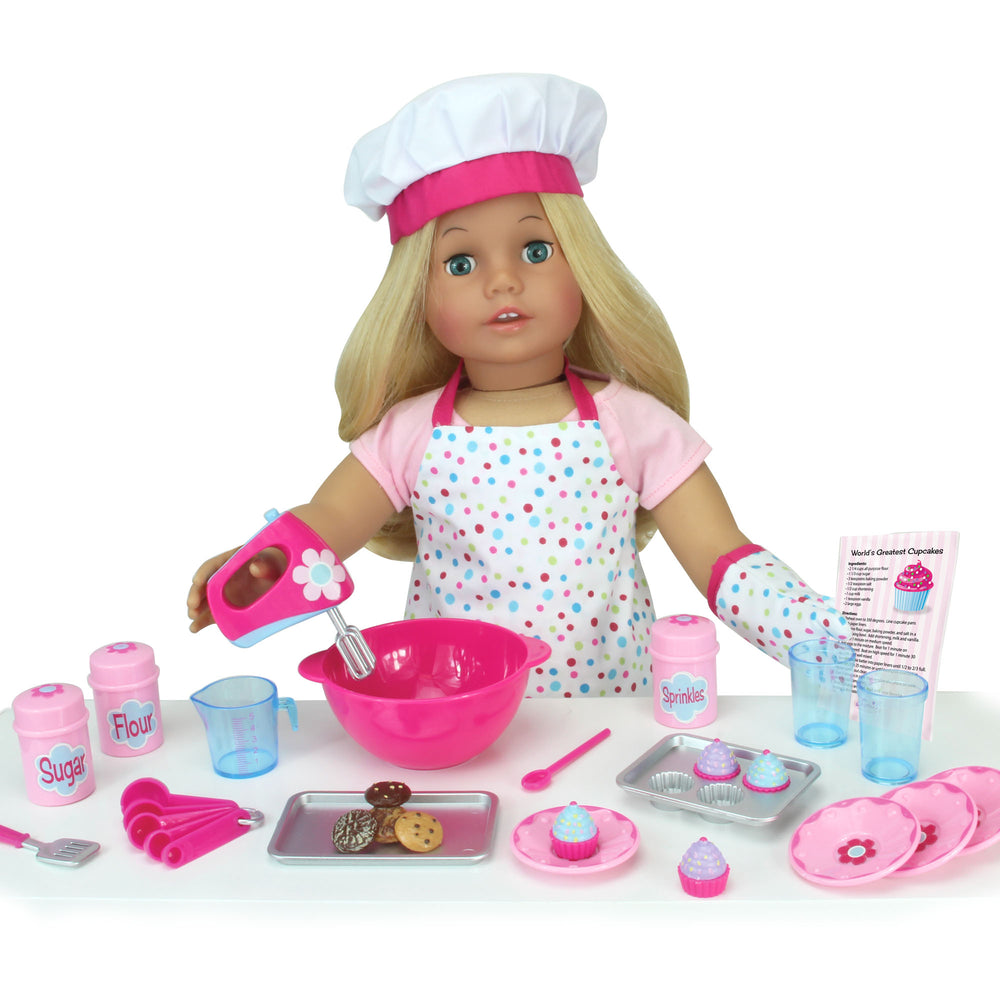 A doll with a chef hat, apron, and Sophia’s Pretend Baking Accessories 26 Piece Set for 18" Dolls.
