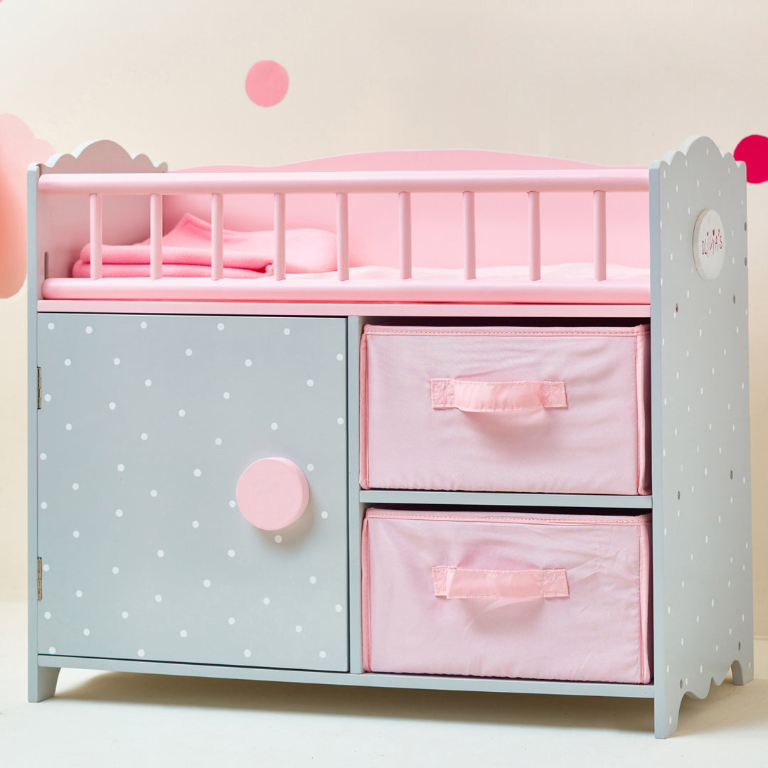 A Olivia's Little World Polka Dots Princess Baby Doll Crib with Storage Closet and Drawers, Gray/Pink with pink polka dots.