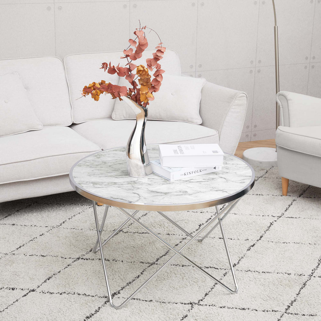 A durable Teamson Home Margo Small Round Faux White Carrara Marble Coffee Table in a living room.