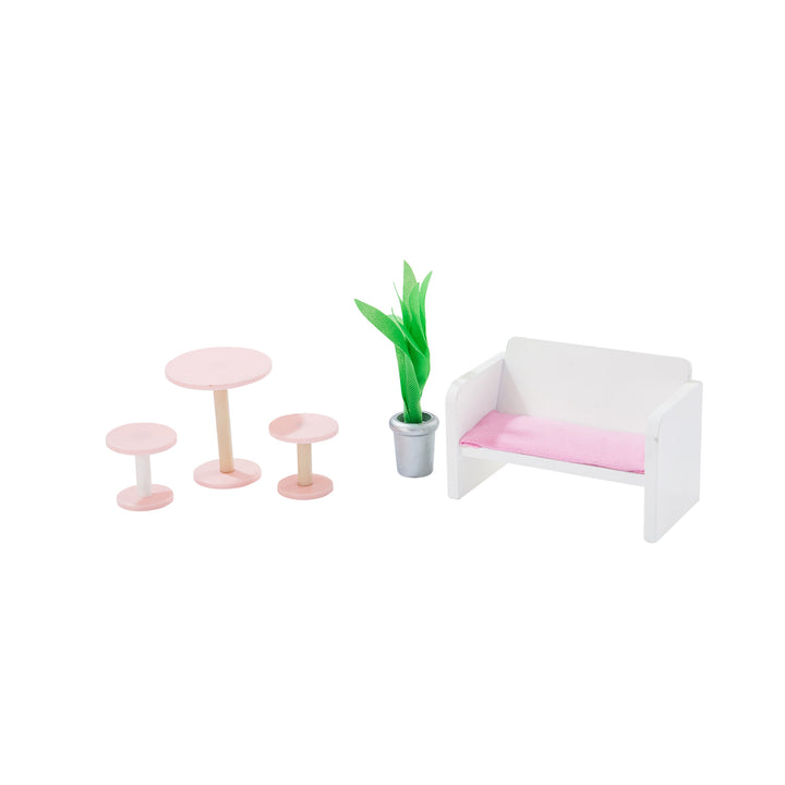 A photo of the accessories - pink cafe table and two stools, a potted plant, and a white and pink sofa.